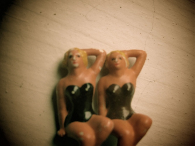 Surreal photo of two chorus girl dolls
