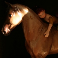 Surreal photo of a doll on a horse