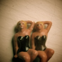 Surreal photo of two chorus girl dolls
